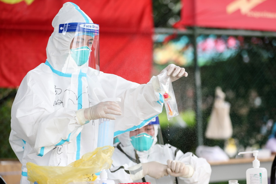 2021年8月11日,扬州主城区某一核酸检测点,医护人员穿戴整齐为居民
