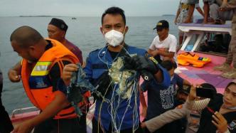 搜救人员在海中打捞出疑似印尼坠毁客机的残骸碎片