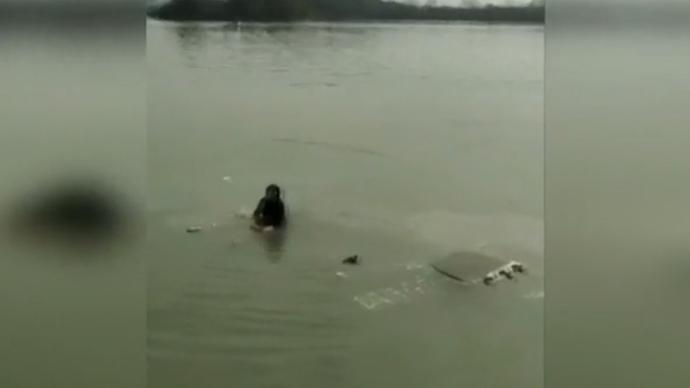 57岁大妈驾车操作不当冲入湖中，爬车顶呼救