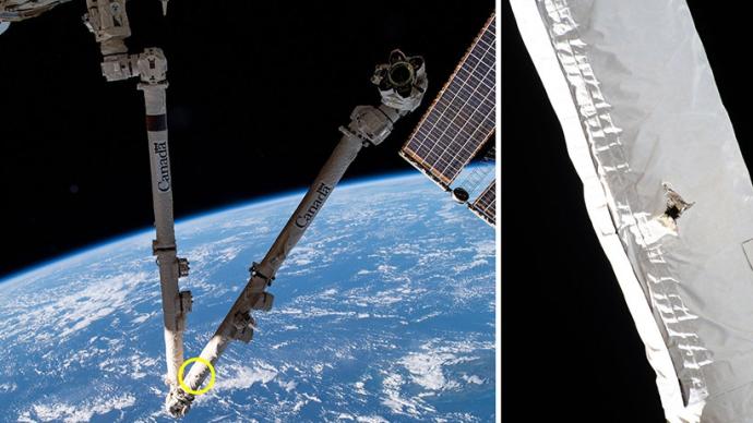 国际空间站一条机械臂遭轨道碎片撞击，表面留下一个洞口