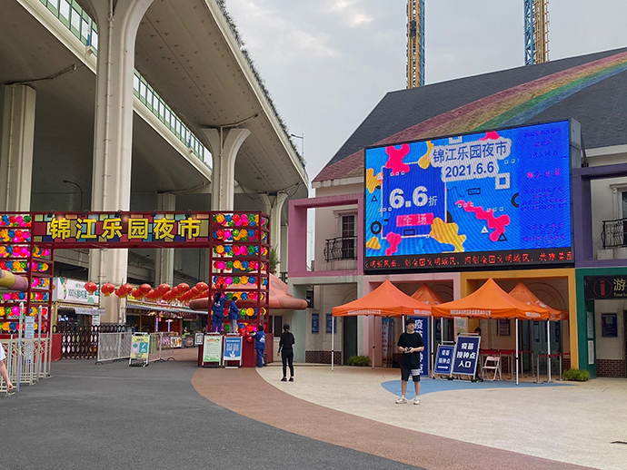 锦江乐园夜市门口的液晶大屏幕上打出了六六夜生活节的活动信息,屏幕