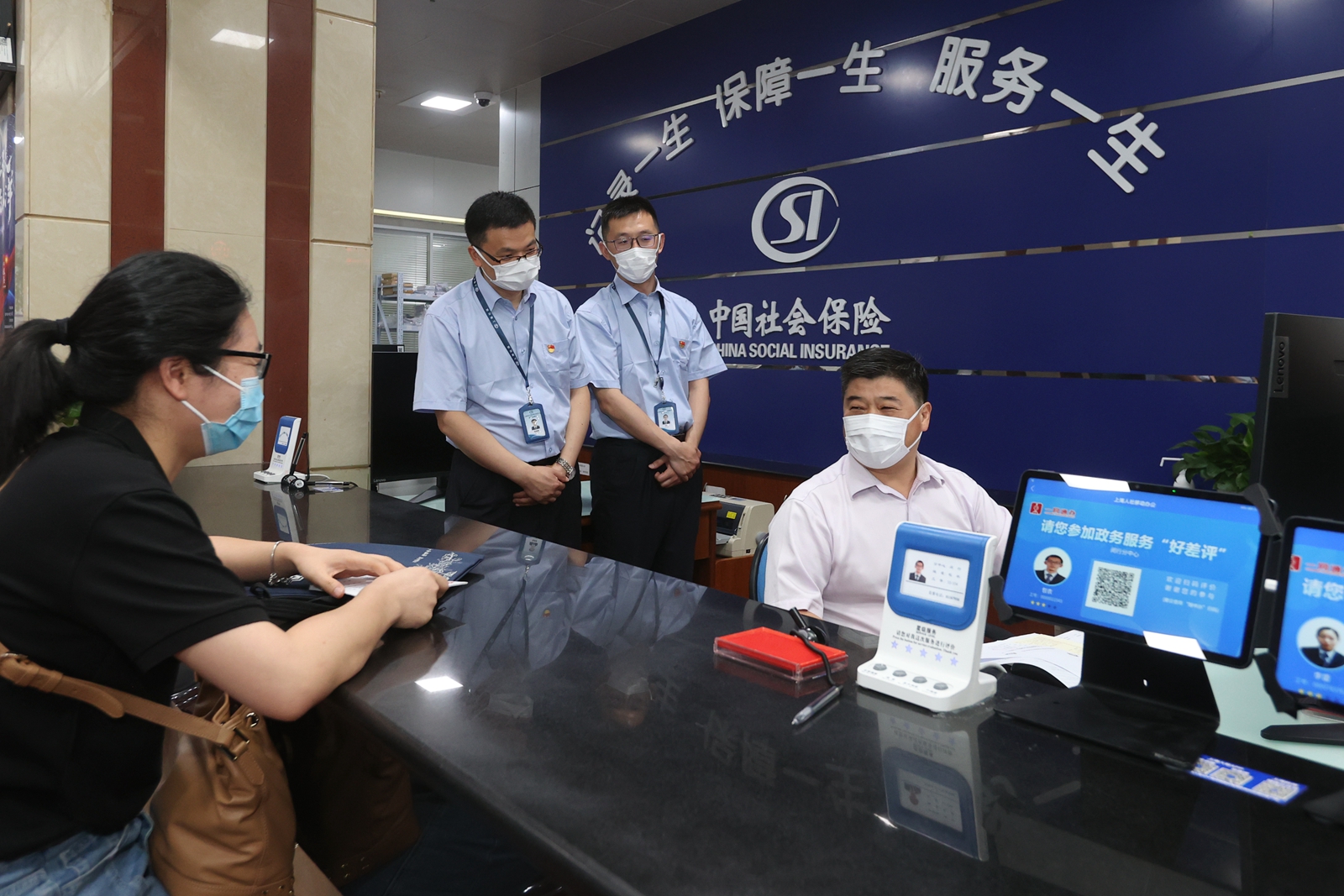 赵永峰（右一）体验 “当一天社保工作人员”  上海市人社局供图