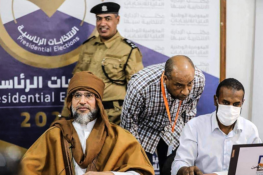 当地时间2021年11月14日，利比亚Sabha，利比亚前领导人穆阿迈尔·卡扎菲的次子赛义夫·伊斯兰·卡扎菲（左）当日现身选举委员会登记处，登记参加总统竞选。