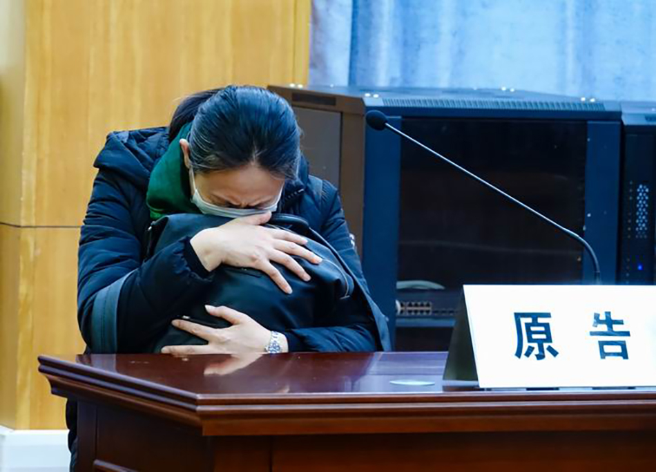 1月10日，江秋莲在法庭上听到判决结果后，紧紧抱着江歌遇害时的背包，失声痛哭。