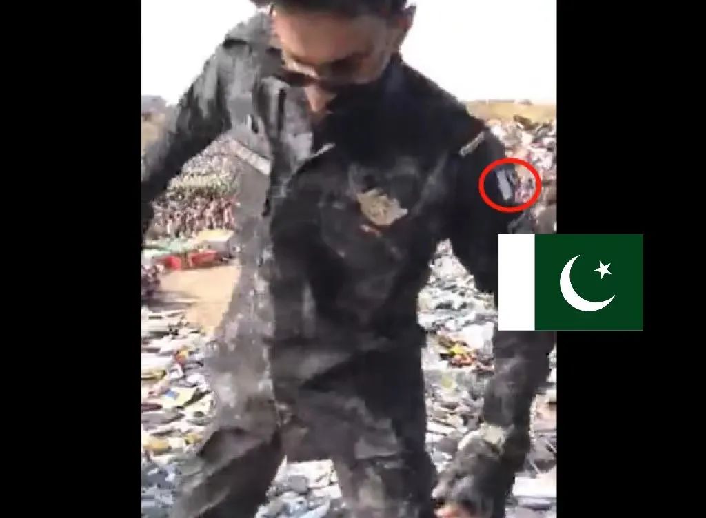 网传“塔利班销毁手机”视频截图中的戴墨镜男子，以及他的巴基斯坦国旗样式袖章。