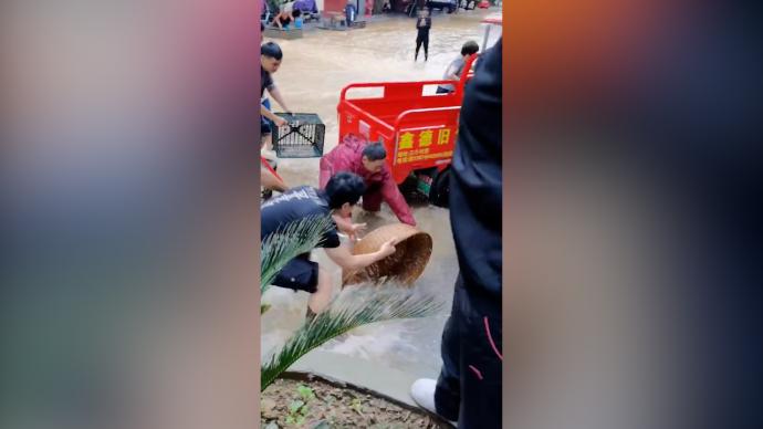 湖南宁远突降暴雨街面积水，市民拿网兜上街捞鱼