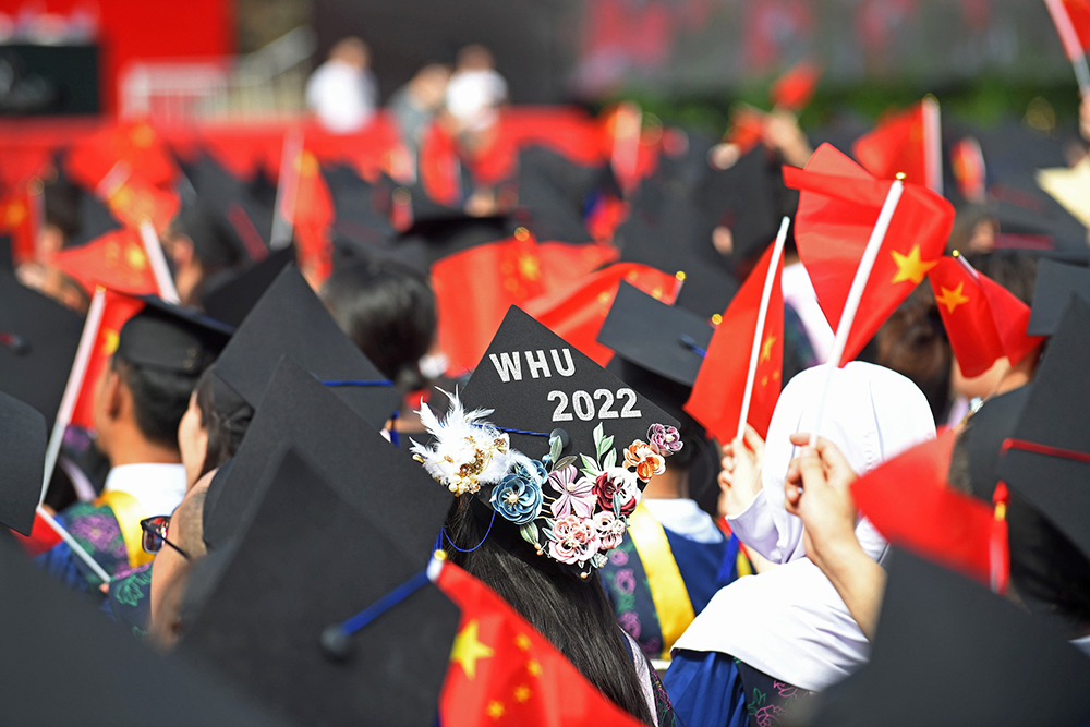 2022年6月22日，武汉大学在九一二操场举行2022年毕业典礼。毕业生们自制花式学士帽出席典礼，创意满满又颇具纪念意义。视觉中国 图