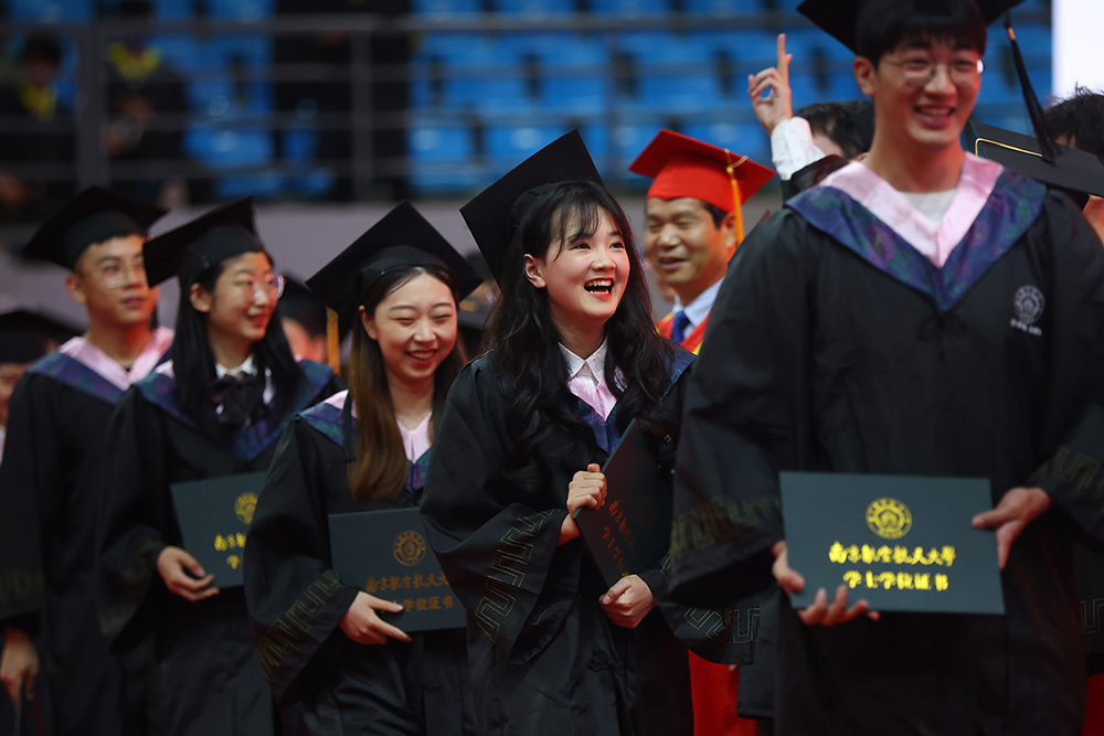 2022年6月21日，南京航空航天大学“我骄傲，我是南航人”2022届本科生毕业典礼暨学位授予仪式在该校将军路校区举行，毕业生们登台领取毕业证书。中新社记者泱波/人民视觉 图