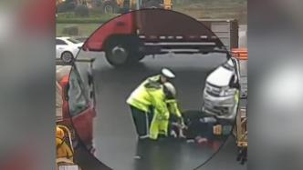 一女子遇车祸受伤倒地，交警为她披上雨衣