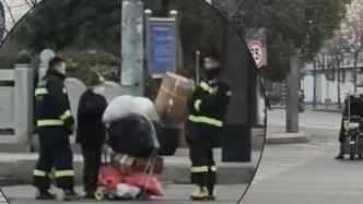 消防员穿过车流帮助老人捡拾掉落东西