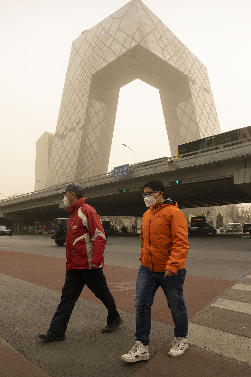 2023年3月22日，北京，人们戴着口罩走过中心商务区的一个十字路口。.jpg