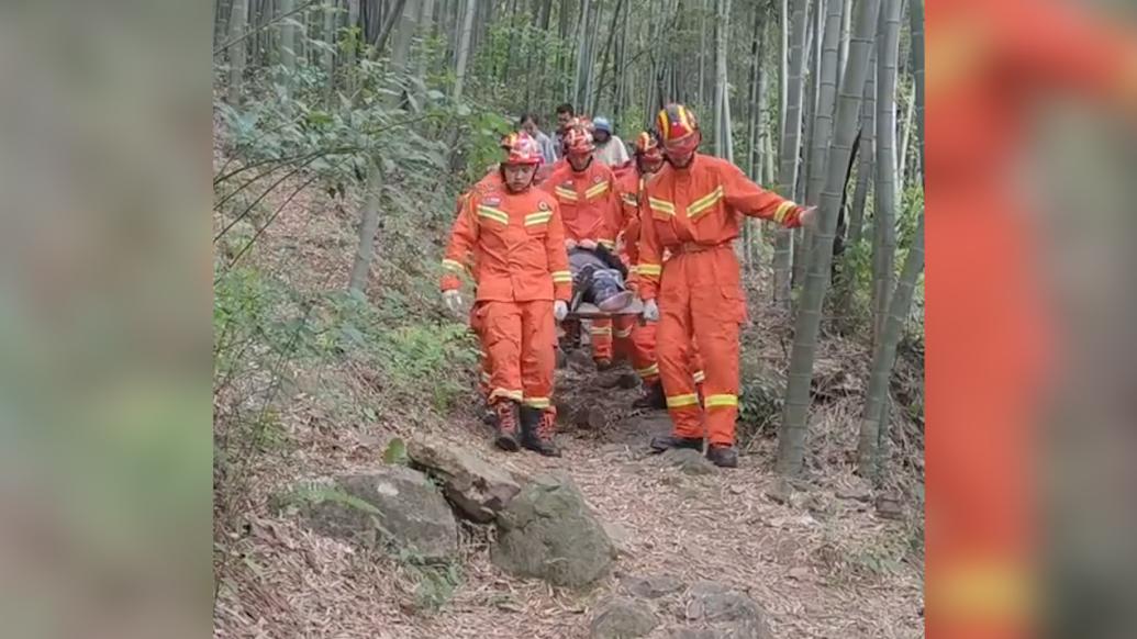 消防员用担架把骨折游客抬下山