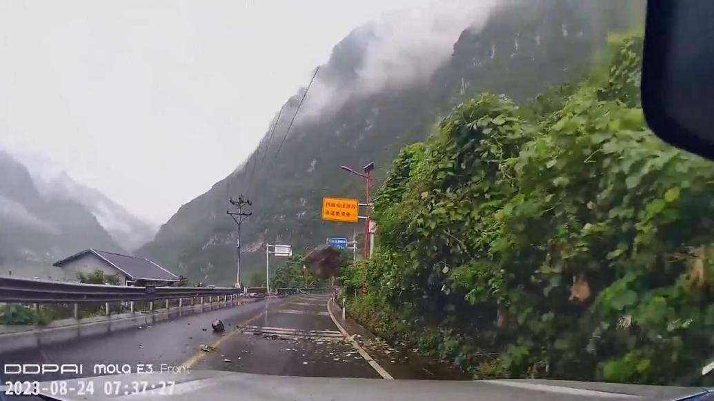 惊险！男子驾车躲开山上滚落的石头