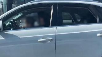 网友拍到武汉一女子抱娃开车还玩手机，交管部门回复属违法