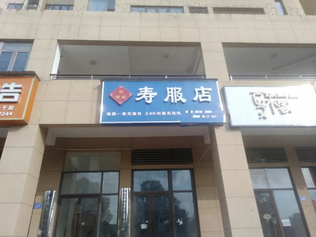长沙市一寿衣店开在小区门口引争议，“寿服店”招牌被物业拆除