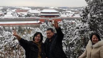 北京龙年首场降雪后，市民到景山俯瞰雪中故宫