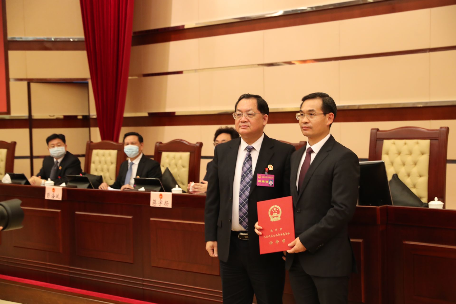 深圳市人大常委会主任骆文智为新当选的副市长聂新平（右））颁发任命书。