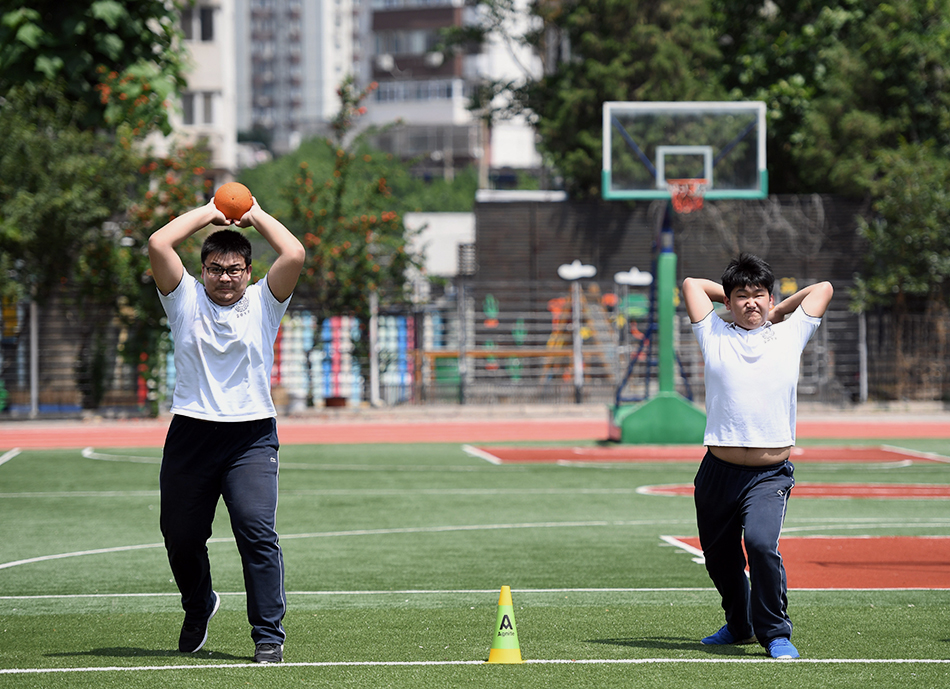 5月28日，北京市第十八中学初三年级的学生在体育课上投掷实心球。