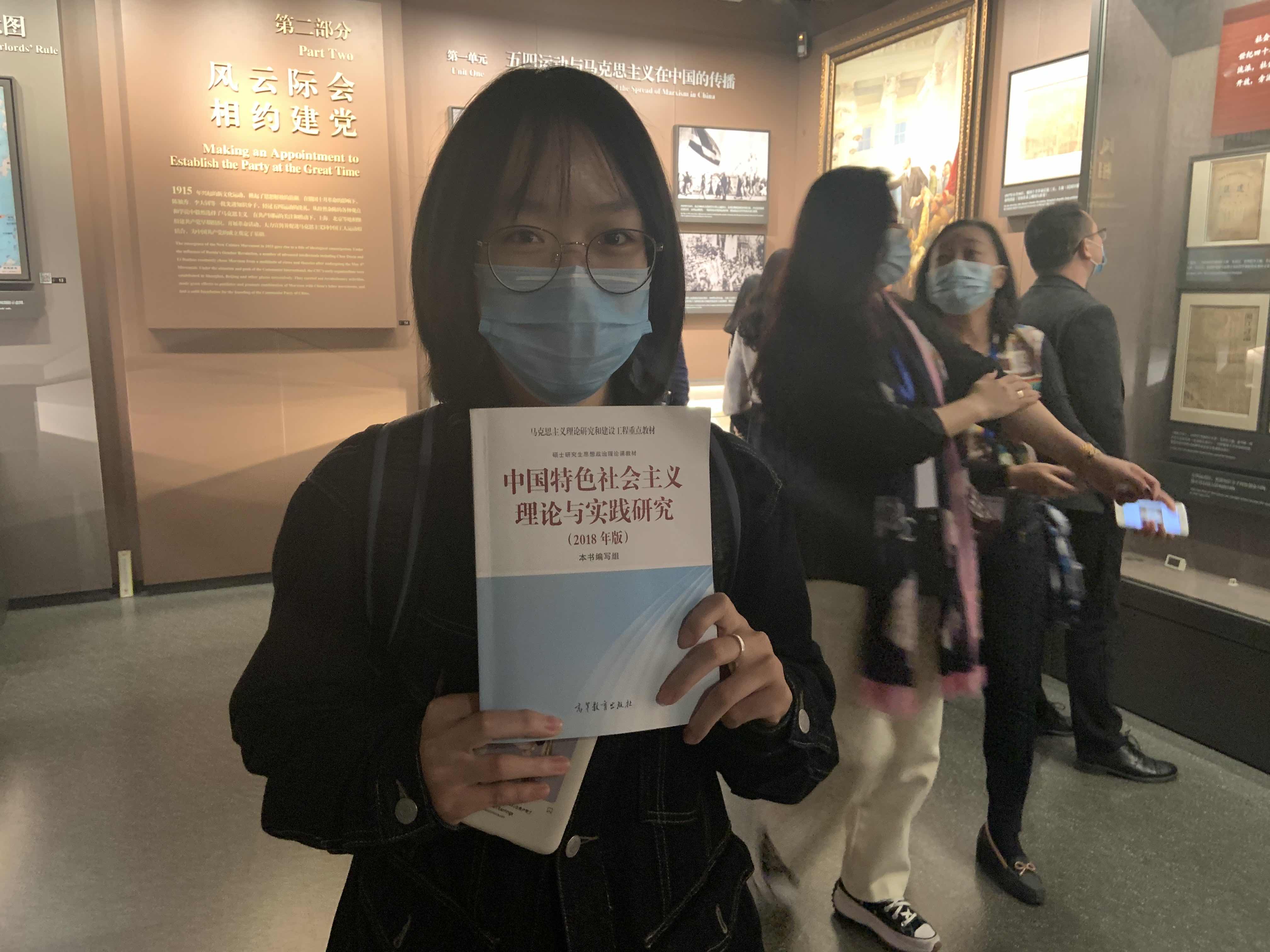 蓝盼盼手里拿着《中国特色社会主义理论与实践研究》。